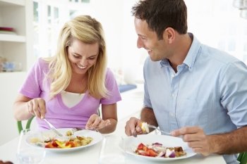 Couple Eating Meal At Home Together