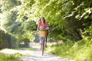 Woman On Cycle Ride In Countryside