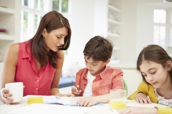Mother Helping Children With Homework