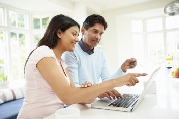Indian Couple Making Online Purchase At Home