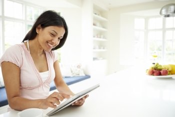 Indian Woman Using Digital Tablet At Home