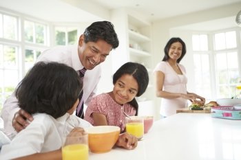 Family Having Breakfast Before Father Leaves For Work