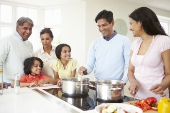 Multi Generation Indian Family Cooking Meal At Home