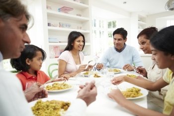 Multi Generation Indian Family Eating Meal At Home