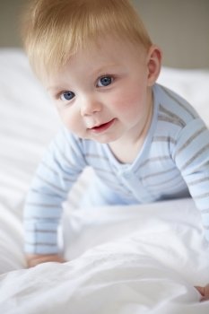 Young Baby Boy Playing In Bed