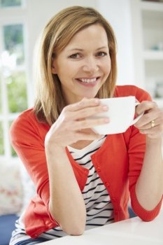 Woman Relaxing At Home With Hot Drink