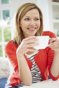 Woman Relaxing At Home With Hot Drink