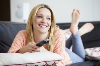 Teenage Girl Relaxing At Home Watching Television
