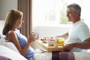 Husband Bringing Wife Breakfast In Bed On Tray
