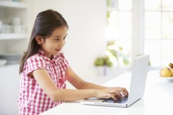 Asian Child Using Laptop At Home