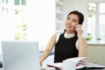 Asian Businesswoman Working From Home Using Mobile Phone