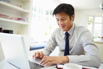 Asian Businessman Working From Home On Laptop