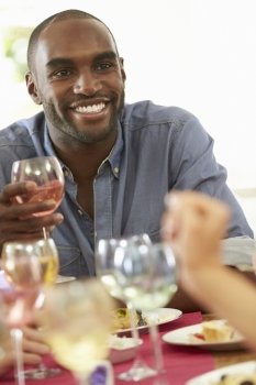 Young Man Relaxing At Dinner Party