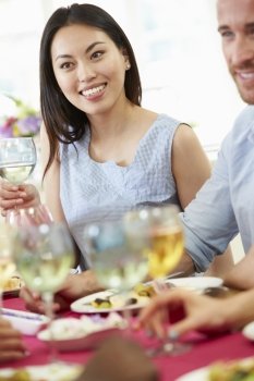 Young Couple Relaxing At Dinner Party
