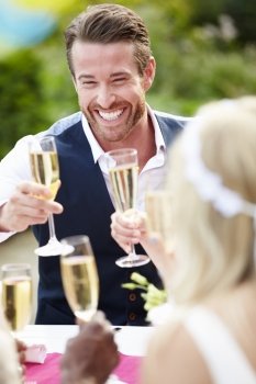 Friends Proposing Champagne Toast At Wedding