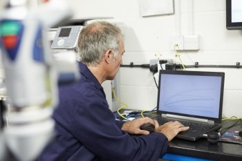 Engineer Using Computerized CMM Arm In Factory