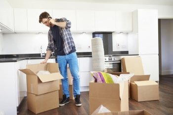 Man Moving Into New Home Talking On Mobile Phone