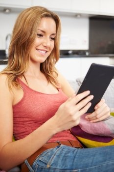 Young Woman Using Digital Tablet At Home