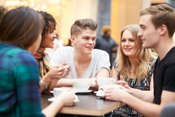 Group Of Young Friends Meeting In Cafe