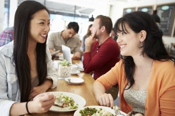 Two Female Friends Friends Meeting For Lunch In Coffee Shop