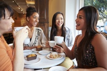 Group Of Female Friends Meeting In Cafe Restaurant