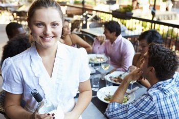 Waitress Serving Tables At Outdoor Restaurant