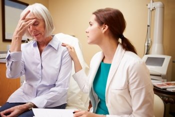 Doctor In Consultation With Senior Concerned Female Patient