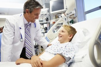 Boy Talking To Male Doctor In Emergency Room