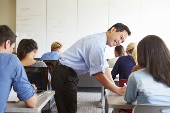 Tutor Helping High School Students In Class