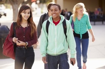 Male And Female Students Walking To High School