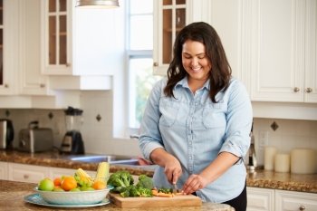 Overweight Woman Preparing Vegetables in Kitchen