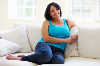 Portrait Of Overweight Woman Sitting On Sofa