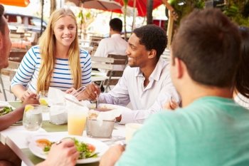 Group Of Friends Enjoying Lunch In Outdoor Restaurant