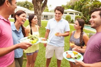 Group Of Friends Having Party In Backyard At Home