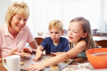 Grandmother And Grandchildren Baking Cookies Together