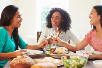 Group Of Female Friends Enjoying Meal At Home