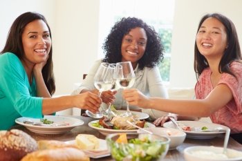 Group Of Female Friends Enjoying Meal At Home