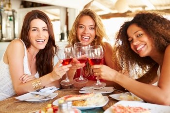 Group Of Female Friends Enjoying Meal In Outdoor Restaurant