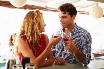 Young Couple Enjoying Drink At Outdoor Bar