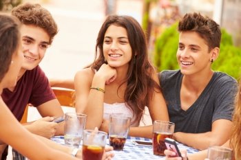 Group Of Teenage Friends Sitting Together At Caf‚