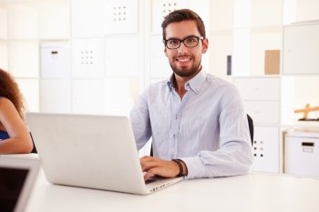 Businessman Using Laptop In Office Of Start Up Business