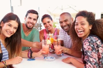 Group Of Friends Drinking Cocktails At Outdoor Bar