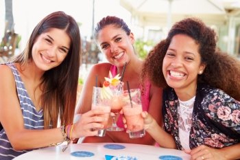 Group Of Female Friends Drinking Cocktails At Outdoor Bar