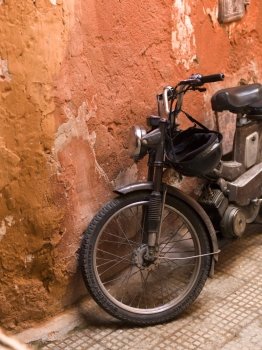 Moped leaning against a weathered wall, Marrakesh, Morocco