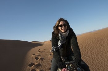 Woman riding a camel in Erg Chegaga Dunes, Sahara Desert, Souss-Massa-Draa, Morocco