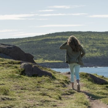 Girl walking at coast, Cape Spear, St. John’s, Newfoundland And Labrador, Canada
