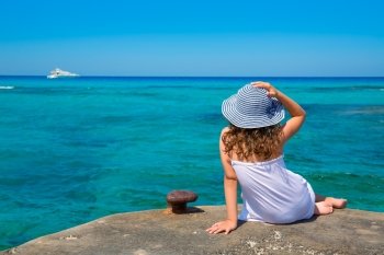 Girl looking at beach in Formentera turquoise Mediterranean sea background