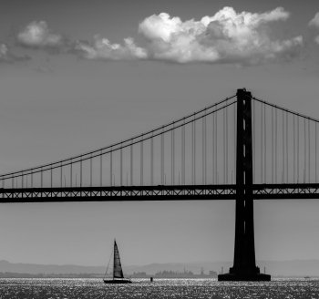 San Francisco Bay bridge sailboat from Pier 7 in California USA