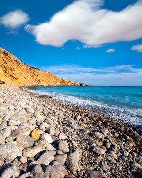 Ibiza Cala Jondal Beach with rolling stones in san Jose at Balearic Islands