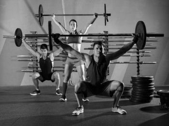 Barbell weight lifting group workout exercise at gym box